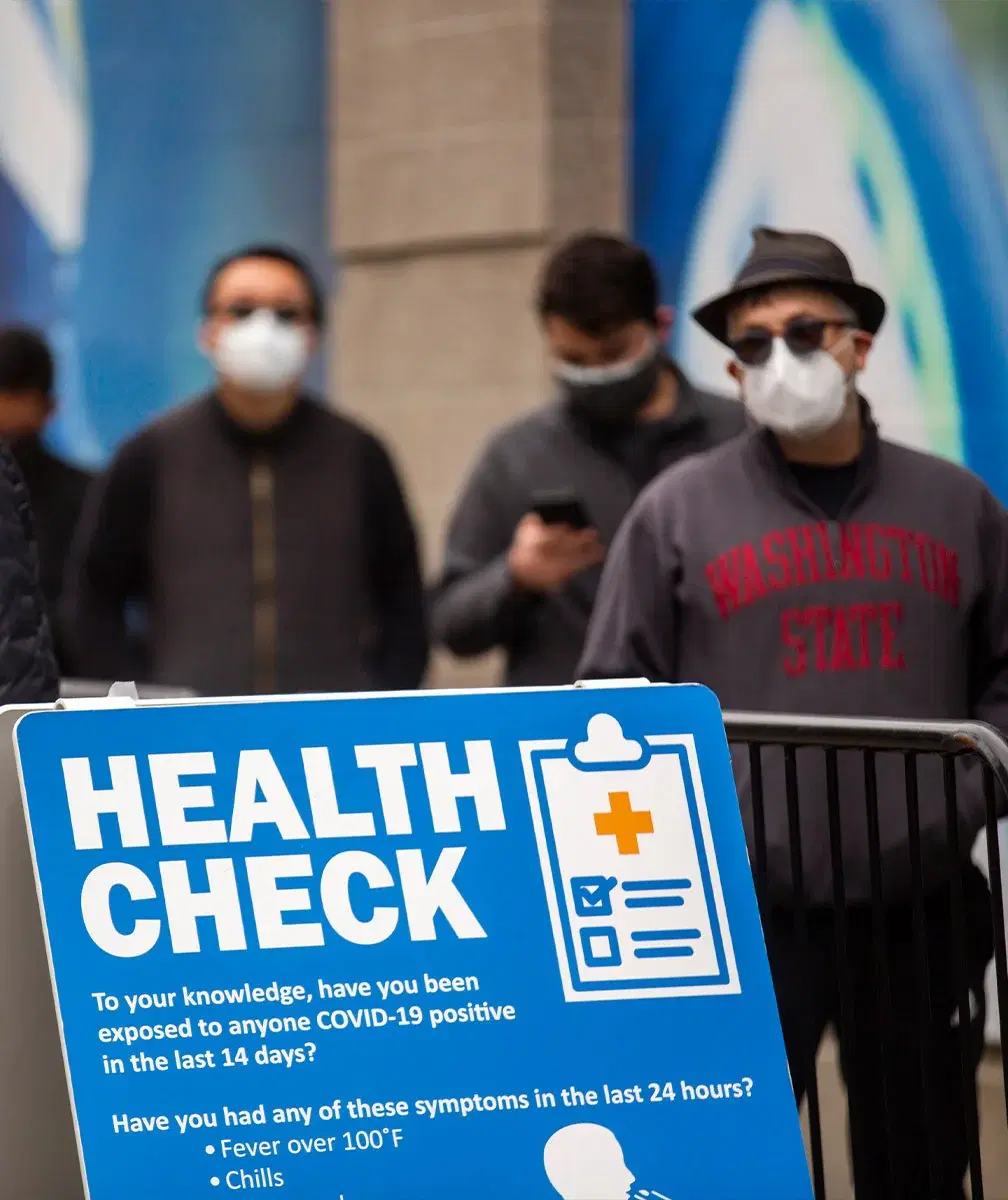 Health check board on front and people wearning mask on the background